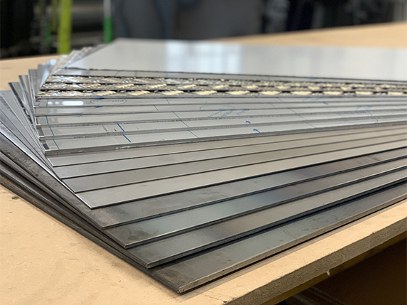 Tôles aluminium striées empilées avec leurs bords et leurs motifs en relief visibles